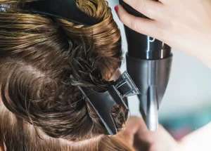 vertical-closeup-shot-hairdresser-blow-drying-woman-s-short-hair-beauty-salon_181624-20887.jpg